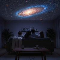 People sitting on a couch in a dimly lit room, watching a projected image of a galaxy.
